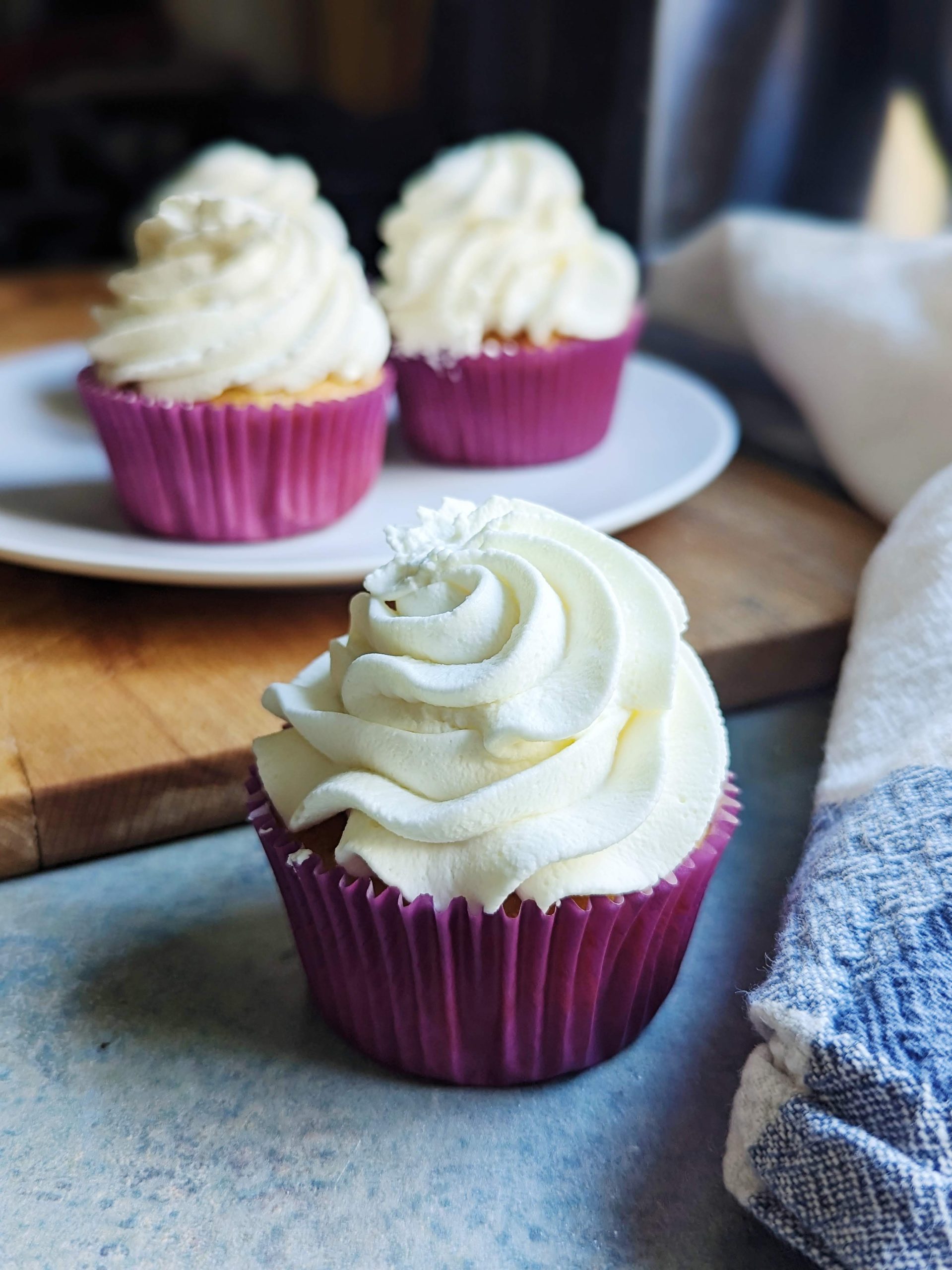 vanilla cupcakes with whipped cream frosting